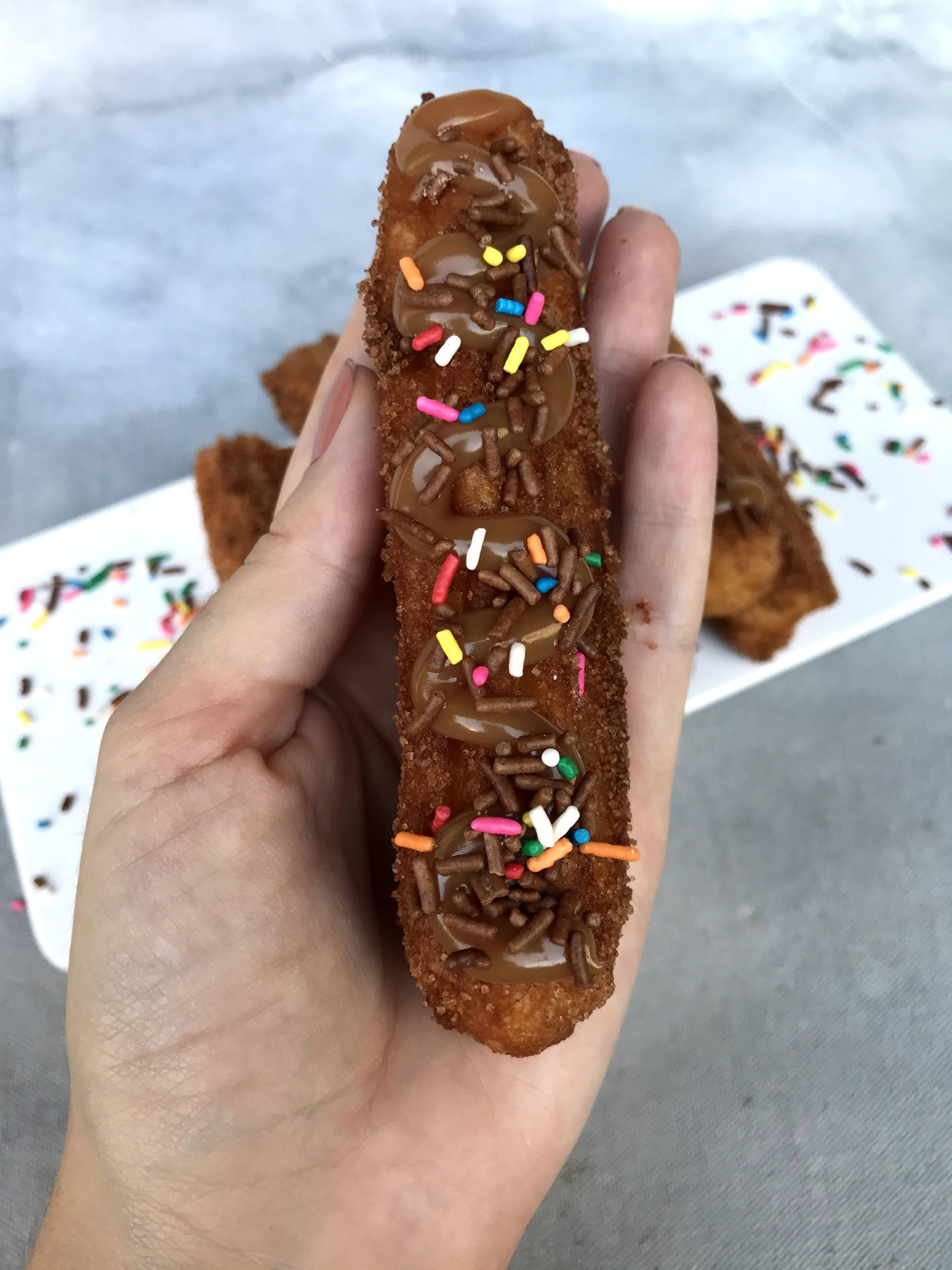 Gluten-free and lactose-free churros with dulce de leche and colored sprinkles (with lactose)